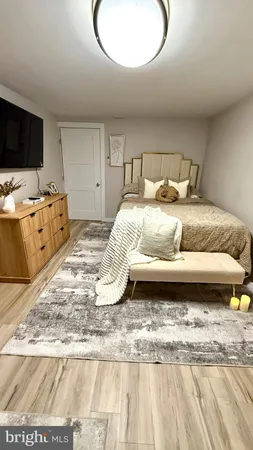 a bedroom with bed and flat screen tv