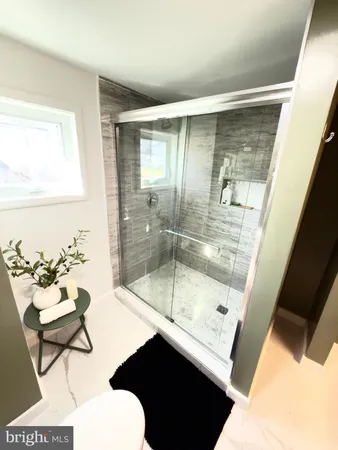 a bathroom with a shower sink and mirror