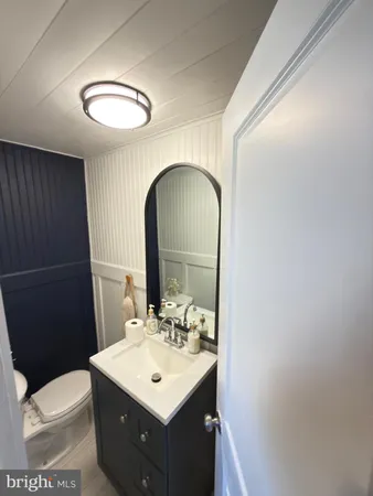 a bathroom with a sink toilet and mirror