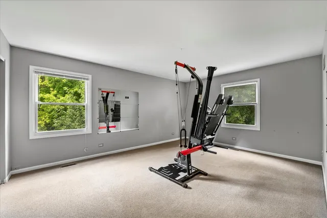 a room with gym equipment and windows