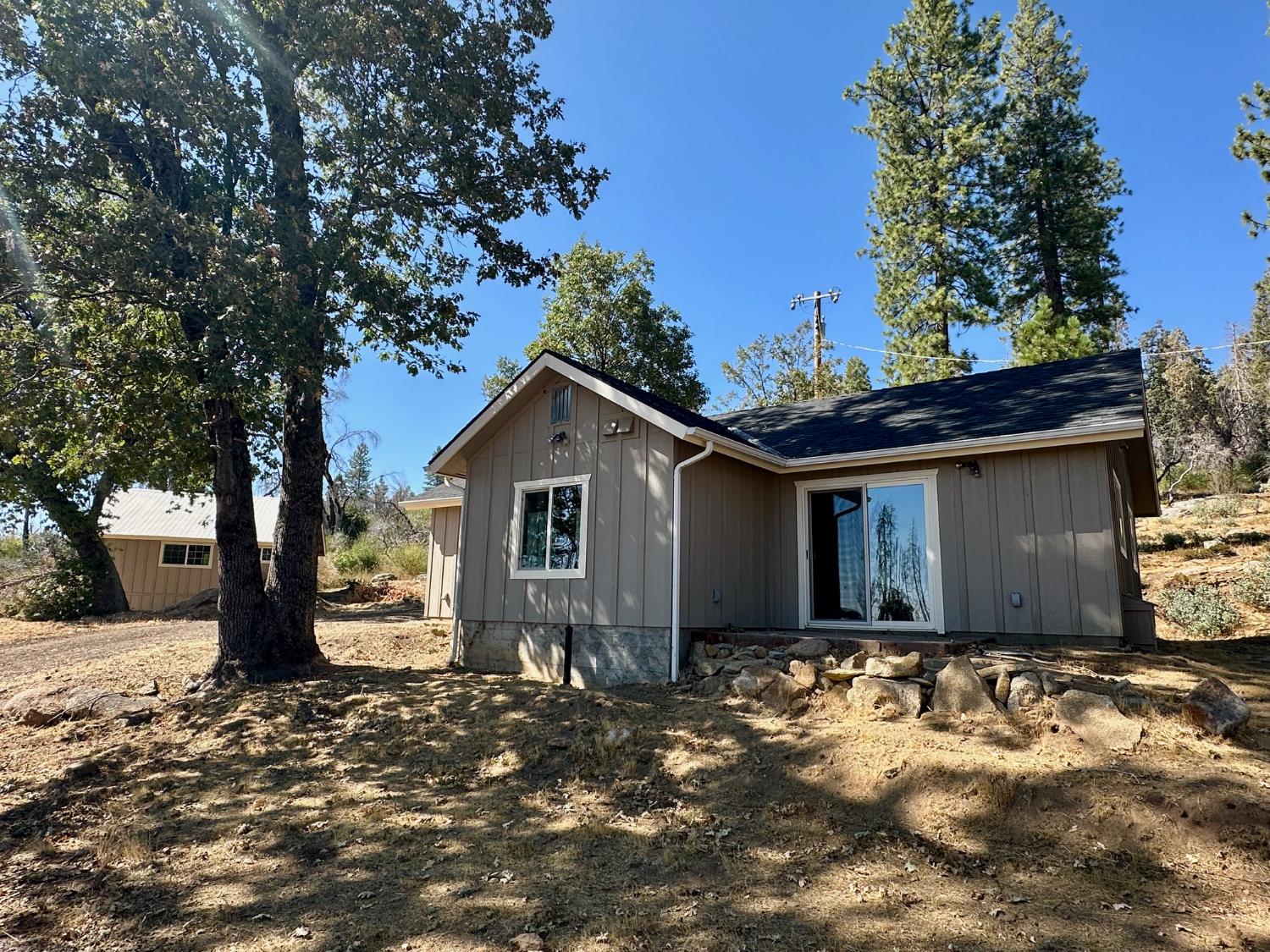 38295 Cressman Road Shaver Lake, CA 93664 - Photo 13 of 31 a front view of house with yard and trees around