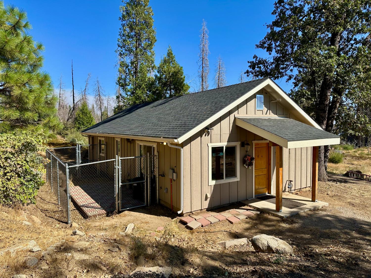 38295 Cressman Road Shaver Lake, CA 93664 - Photo 16 of 31 a view of a house with wooden fence and floor
