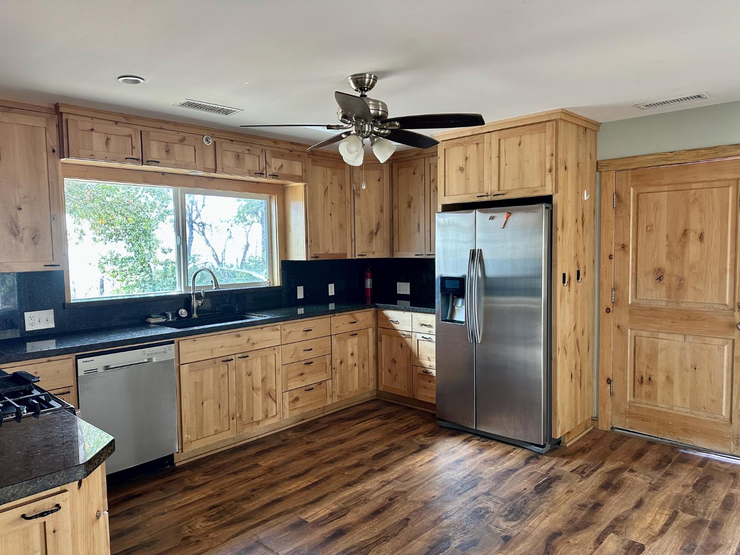 38295 Cressman Road Shaver Lake, CA 93664 - Photo 2 of 31 a kitchen with stainless steel appliances a refrigerator sink and cabinets