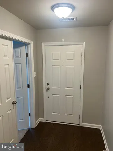 an empty room with wooden floor