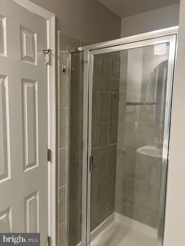 a bathroom with a glass shower door