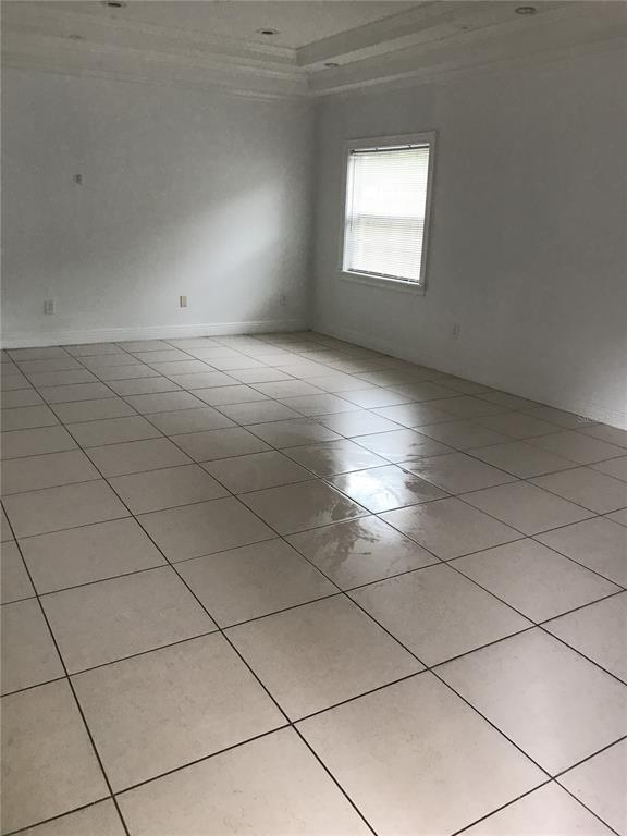 1911 May Street Brandon, FL 33510 - Photo 3 of 9 an empty room with white walls and a window