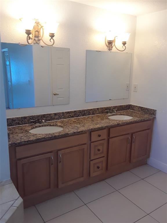 1911 May Street Brandon, FL 33510 - Photo 8 of 9 a bathroom with a granite countertop sink and mirror