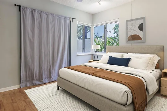 a bedroom with a bed and a window