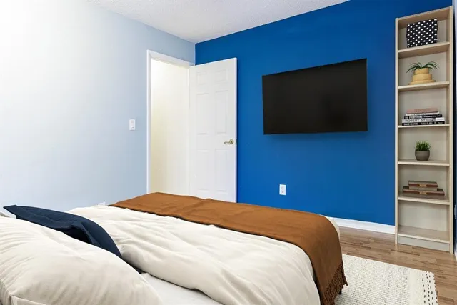 a bedroom with a bed and a flat screen tv
