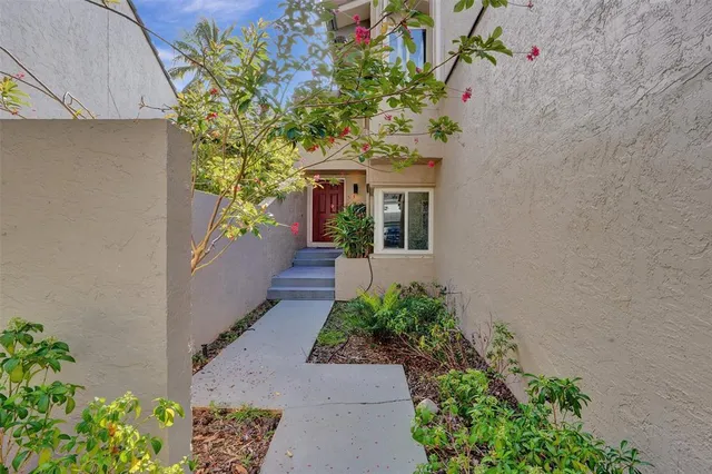 a view of a house with potted plants