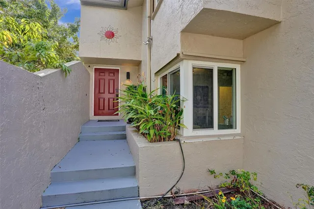 a potted plant sitting in front of a house