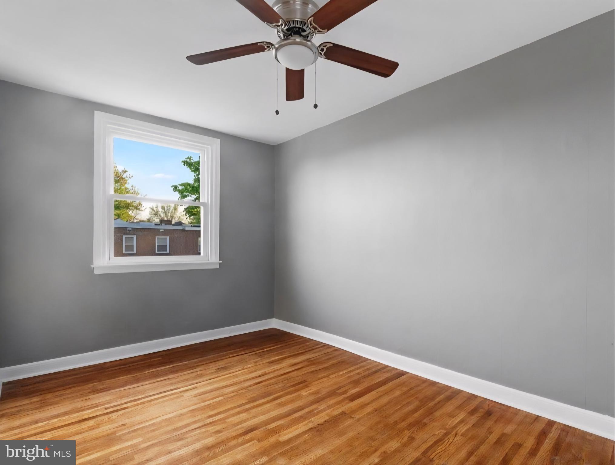 8332 Forrest Avenue Philadelphia, PA 19150 - Photo 11 of 19 wooden floor in an empty room with a window
