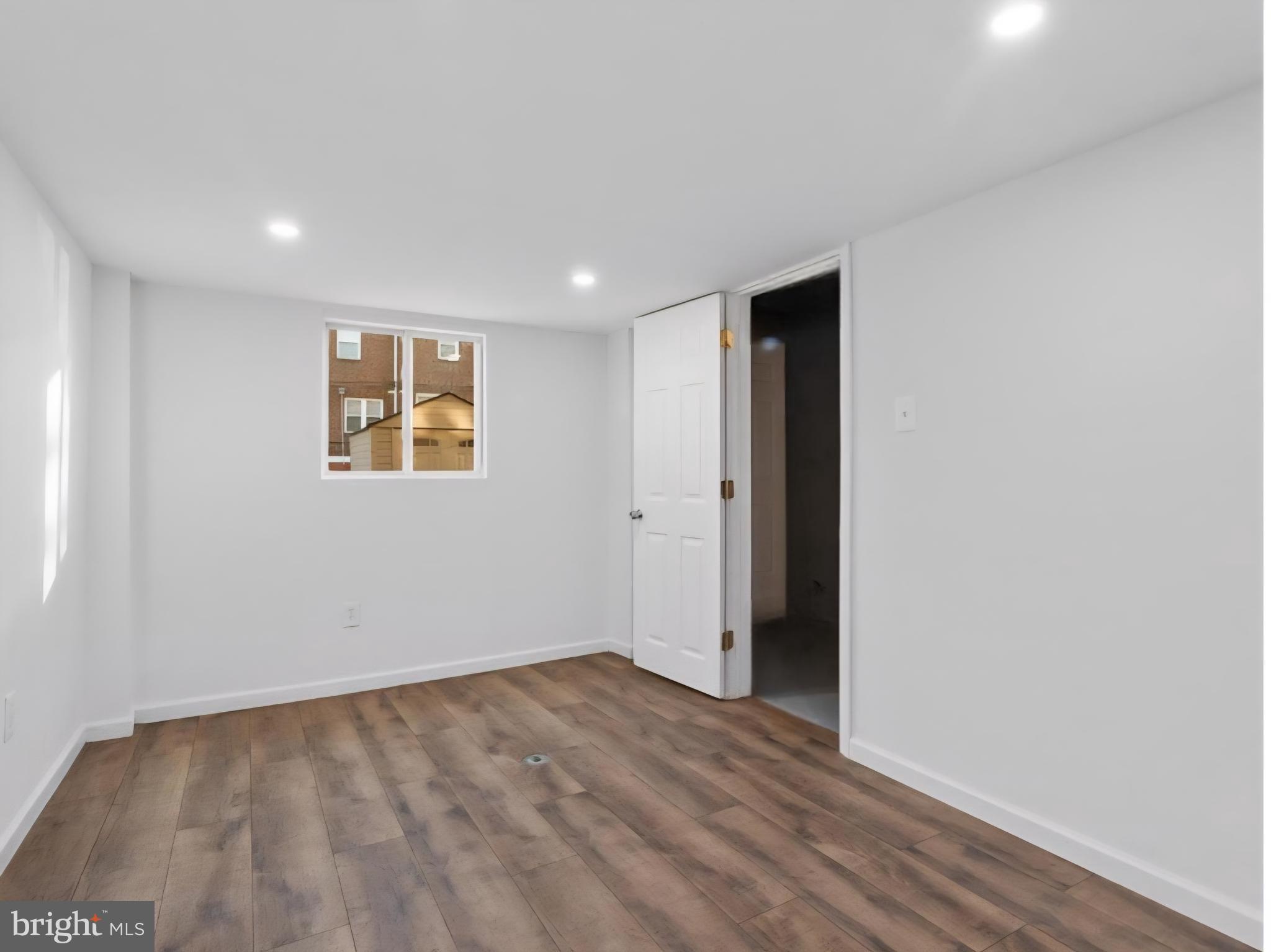 8332 Forrest Avenue Philadelphia, PA 19150 - Photo 16 of 19 an empty room with wooden floor and a window