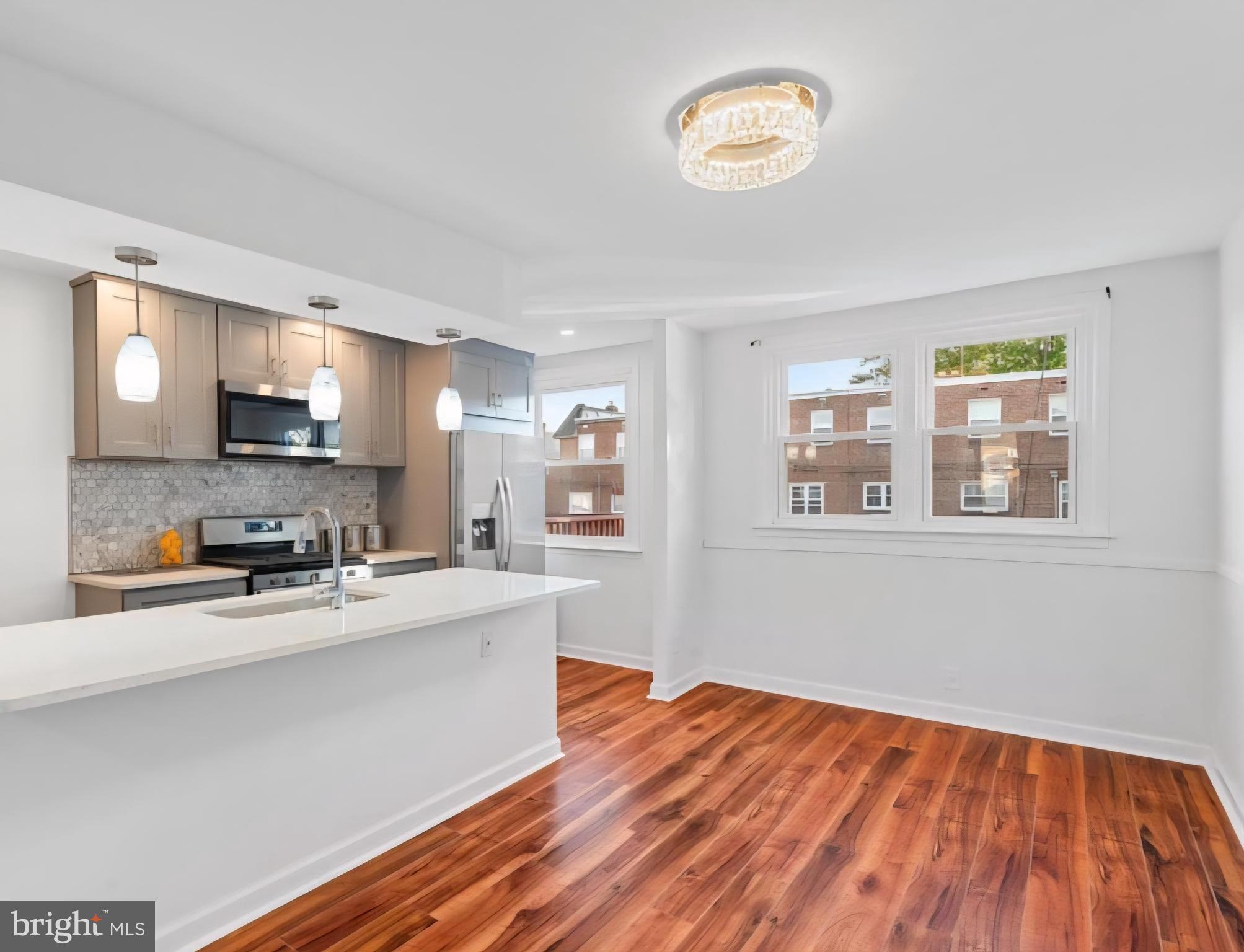 8332 Forrest Avenue Philadelphia, PA 19150 - Photo 5 of 19 a kitchen with stainless steel appliances a refrigerator sink and microwave
