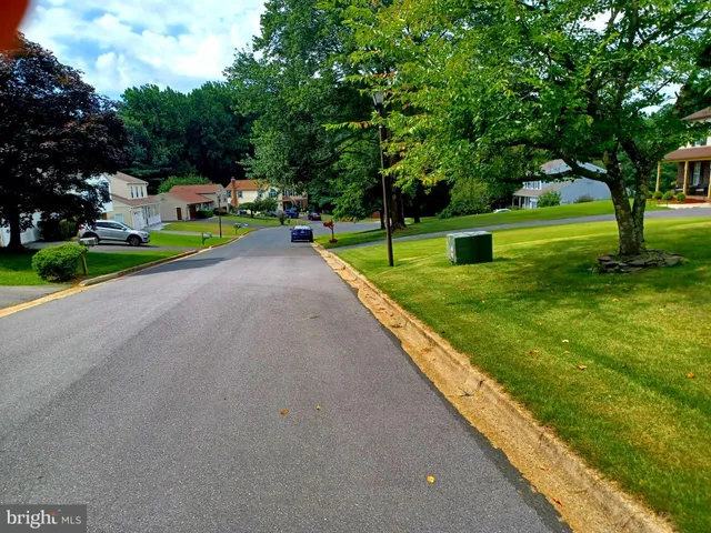 a bedroom with a bed and a refrigerator