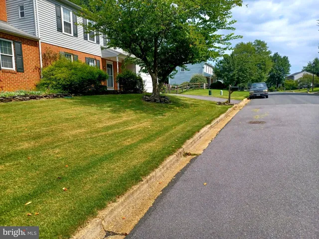 a kitchen with stainless steel appliances granite countertop a refrigerator a stove and a microwave with wooden floor