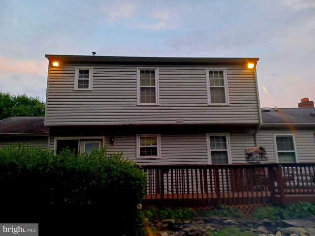 a living room with furniture a large window and a fireplace