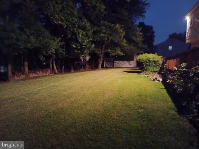 a bedroom with a bed and a flat tv screen on dresser