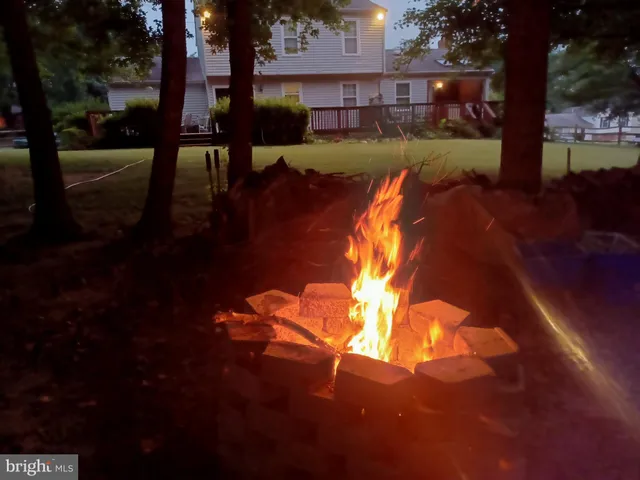 a living room with a bed and a lamp on table
