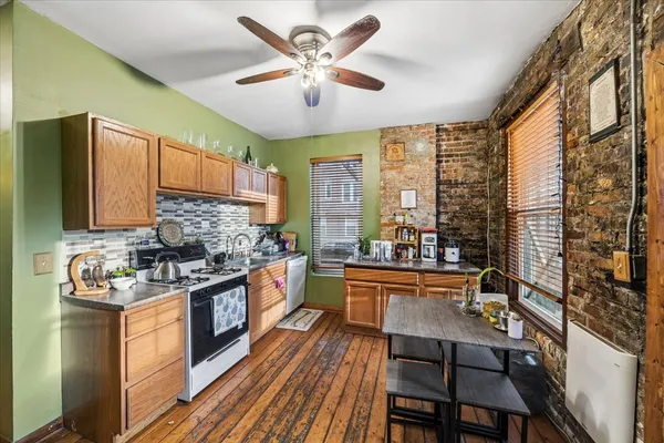 a kitchen with a stove a sink and a refrigerator