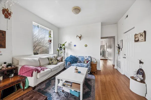 a living room with furniture and wooden floor