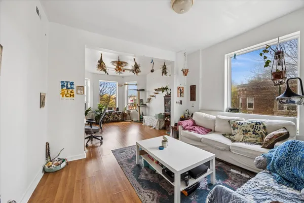 a living room with furniture and wooden floor