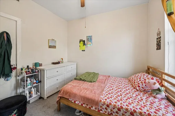 a bedroom with a bed and a dresser