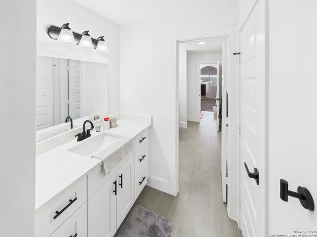 a bathroom with a double vanity sink a mirror and a