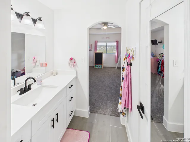a bathroom with a sink vanity and a mirror