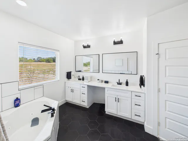 a kitchen with a sink a stove and cabinets