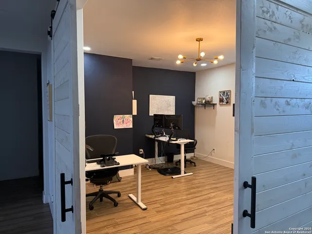 a view of a livingroom with furniture and a workspace