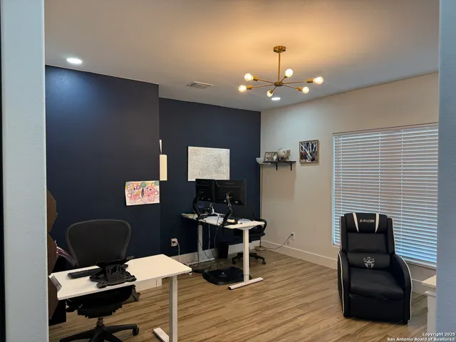 a work room with furniture and wooden floor