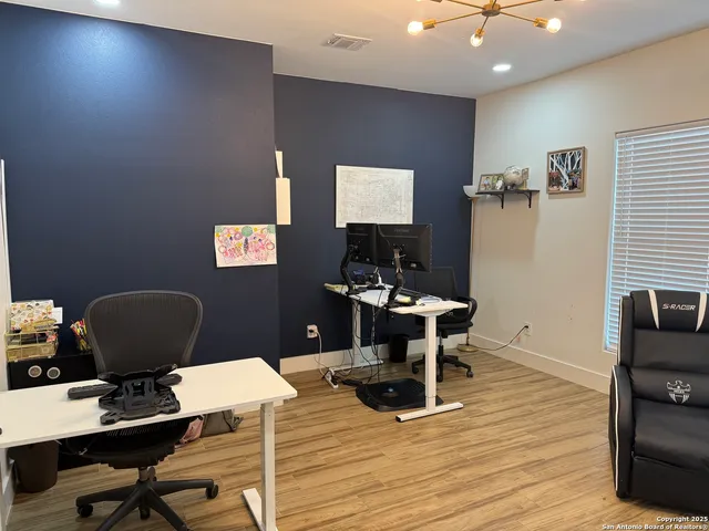 a workspace with furniture and wooden floor