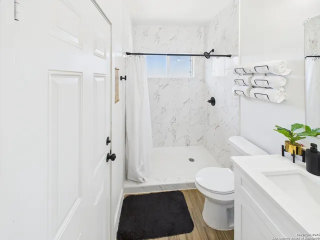 a bathroom with a toilet a sink and a bathtub