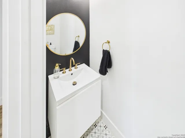 a bathroom with a sink and a mirror