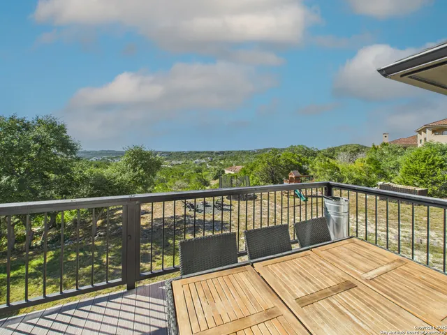 a view of balcony with wooden floor and fence
