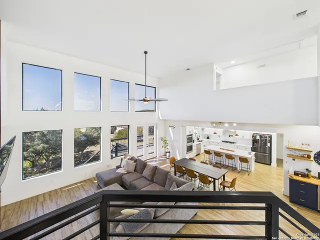 a living room with furniture kitchen view and large window
