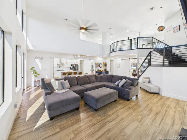 a living room with furniture and a chandelier