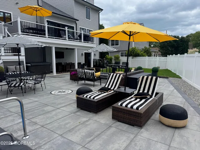 a view of a livingroom with a fireplace and a chandelier fan