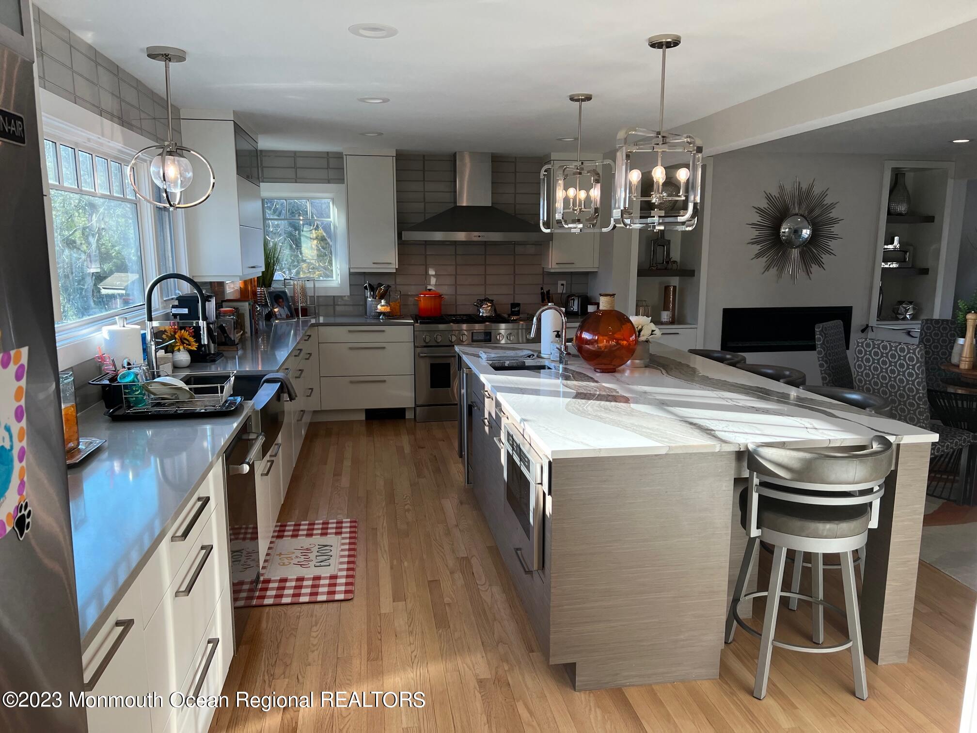 141 Osborn Avenue Bay Head, NJ 08742 - Photo 15 of 48 a kitchen view with stainless steel appliances granite countertop a stove a refrigerator a oven a dining table and chairs with wooden floor