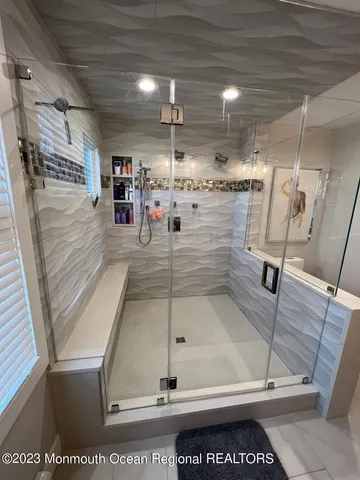 a large bed sitting in a bedroom next to a window