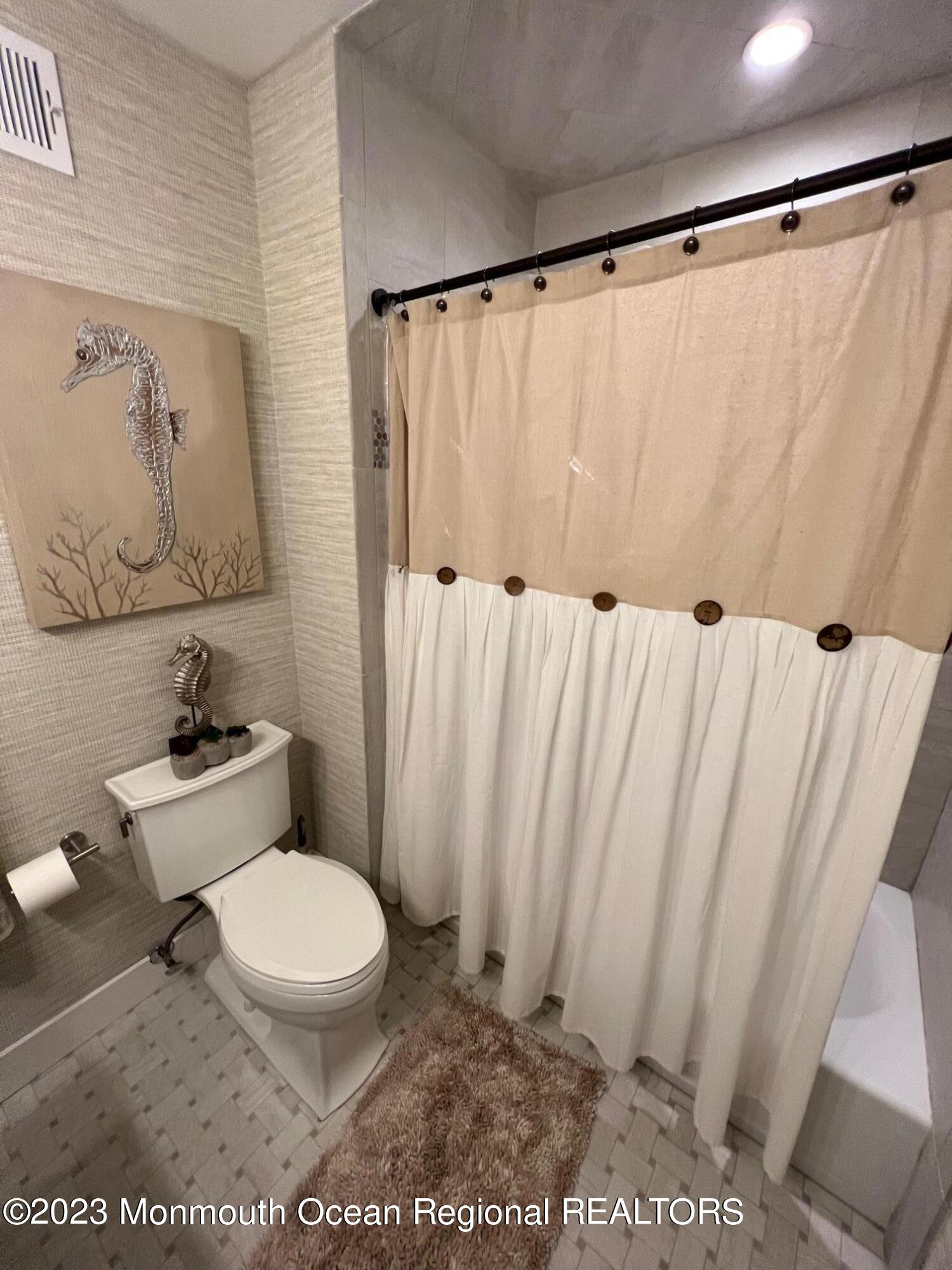 141 Osborn Avenue Bay Head, NJ 08742 - Photo 33 of 48 a white toilet sitting next to a shower curtain