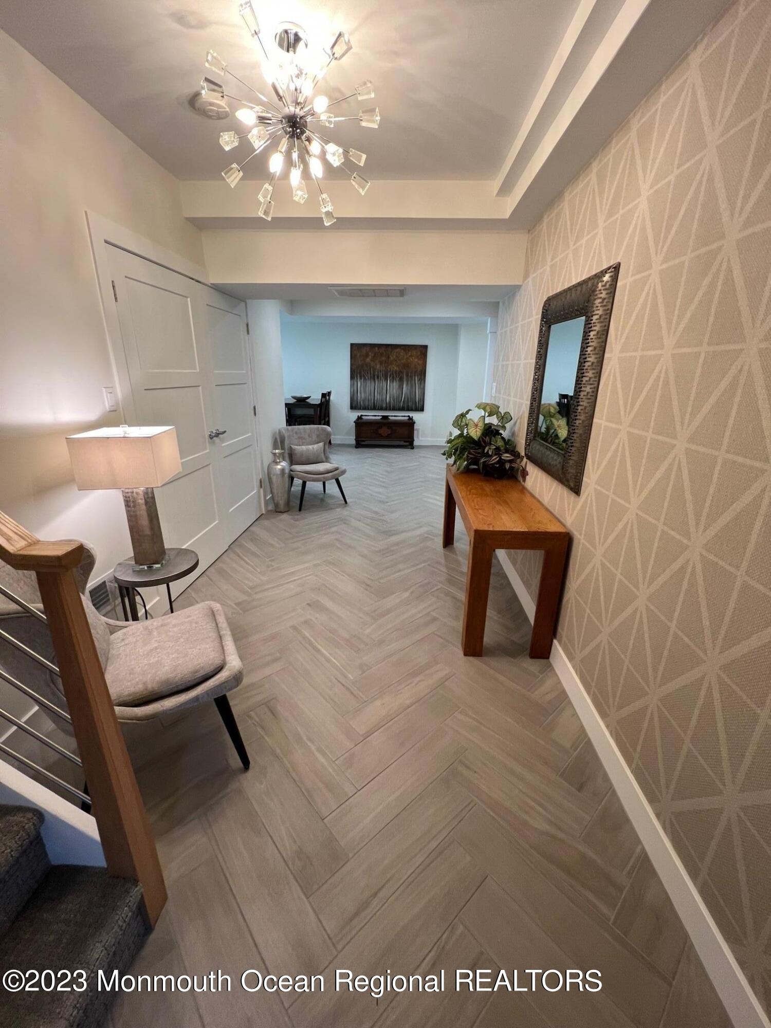 141 Osborn Avenue Bay Head, NJ 08742 - Photo 45 of 48 a living room with furniture a chandelier and a rug