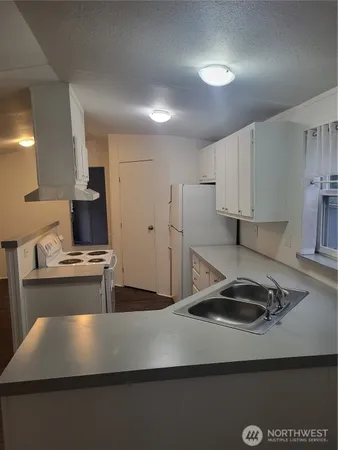 a kitchen with kitchen island a sink stainless steel appliances and cabinets