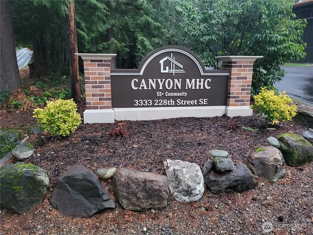 a sign broad in front of red brick house
