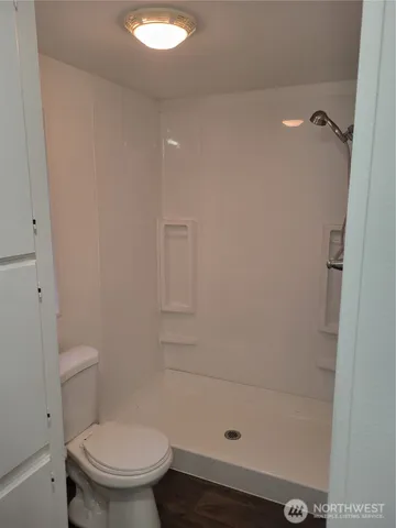 a bathroom with a shower and a toilet