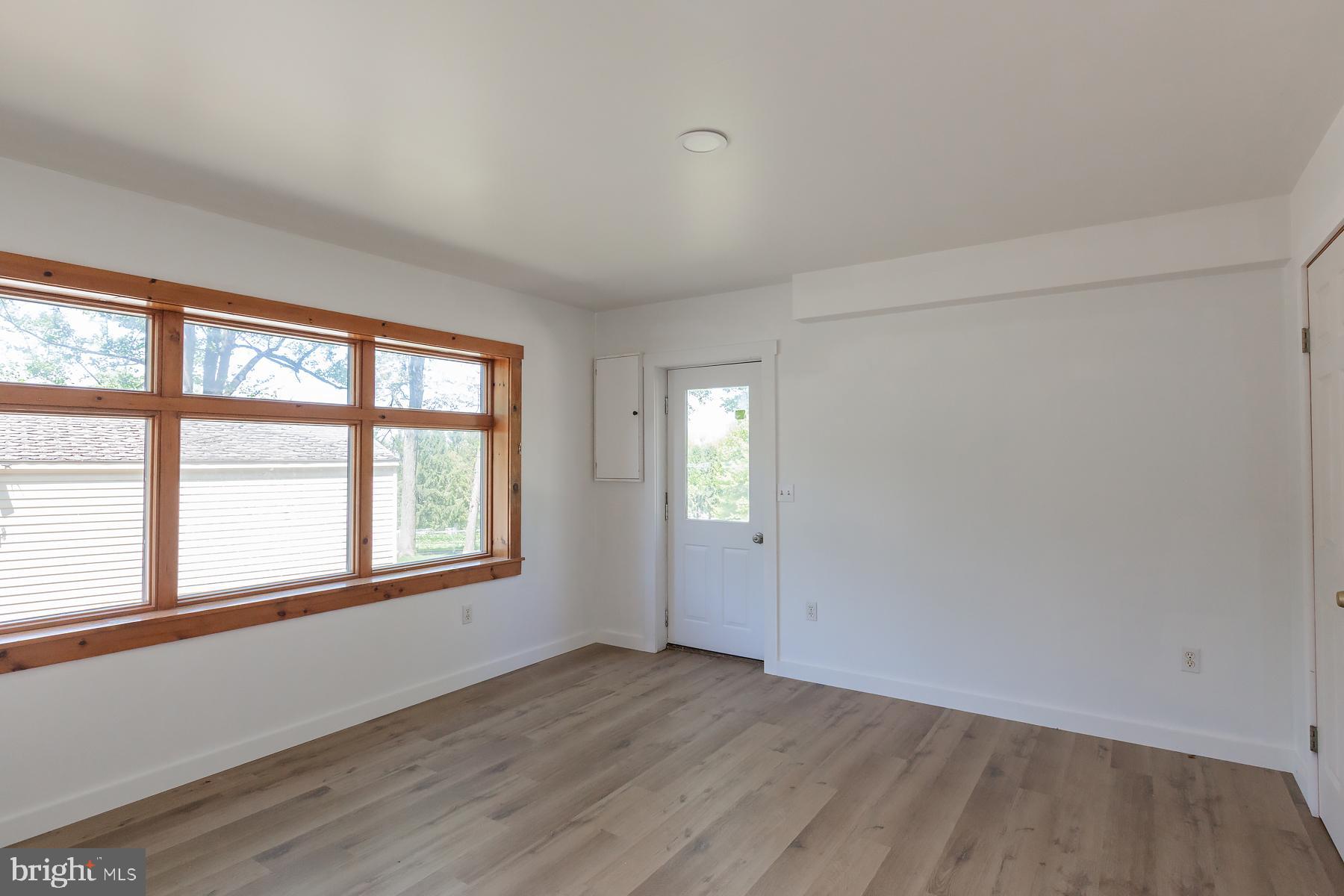 451 Red Hill Road Pequea, PA 17565 - Photo 36 of 52 an empty room with wooden floor and windows