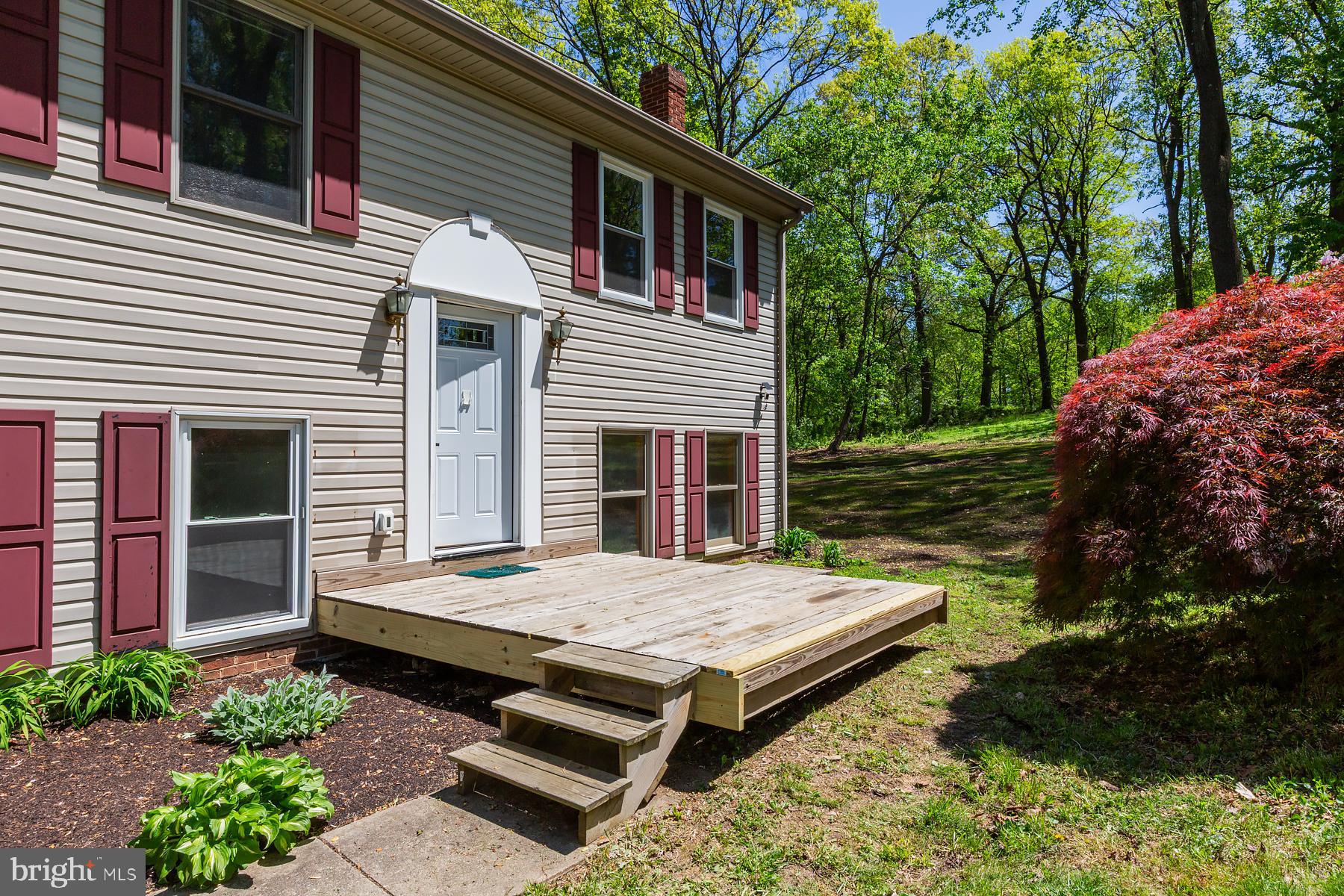 451 Red Hill Road Pequea, PA 17565 - Photo 50 of 52 a view of a wooden chairs and table in the back yard of the house