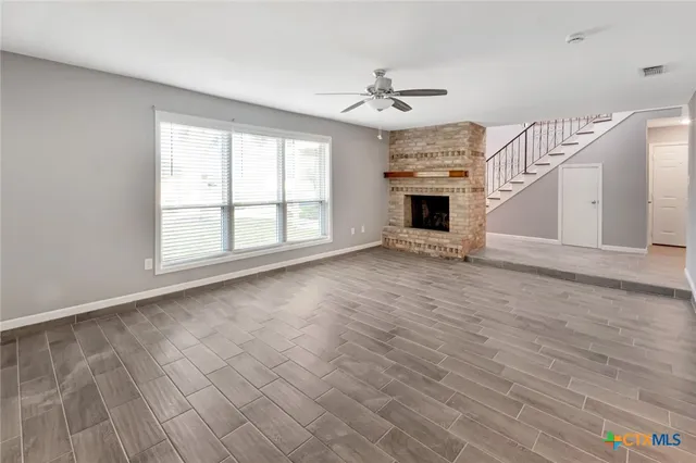 a view of an empty room with a fireplace