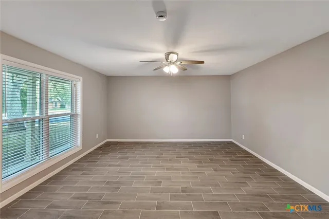 wooden floor in an empty room with a window